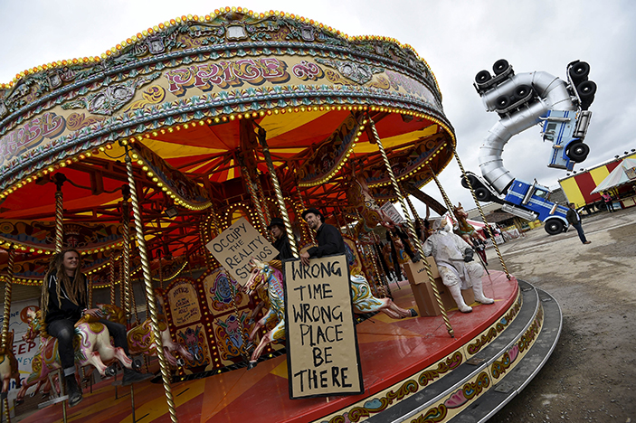 People ride a carousel at 'Dismaland', a theme park-styled art installation by British artist Banksy, at Weston-Super-Mare in southwest England, Britain, August 20, 2015. REUTERS/Toby Melville